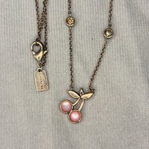 Coach Cherry Pendant Necklace with a rose gold-tone chain and pink cherry charm